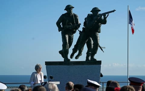 Theresa May standing in front of the sculpture - Credit: PA