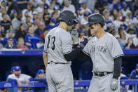 New York Yankees' Anthony Rizzo, right, and Joey Gallo (13) celebrate after Rizzo hit a grand slam against the Toronto Blue Jays during the fifth inning of a baseball game Friday, June 17, 2022, in Toronto. (Christopher Katsarov/The Canadian Press via AP)