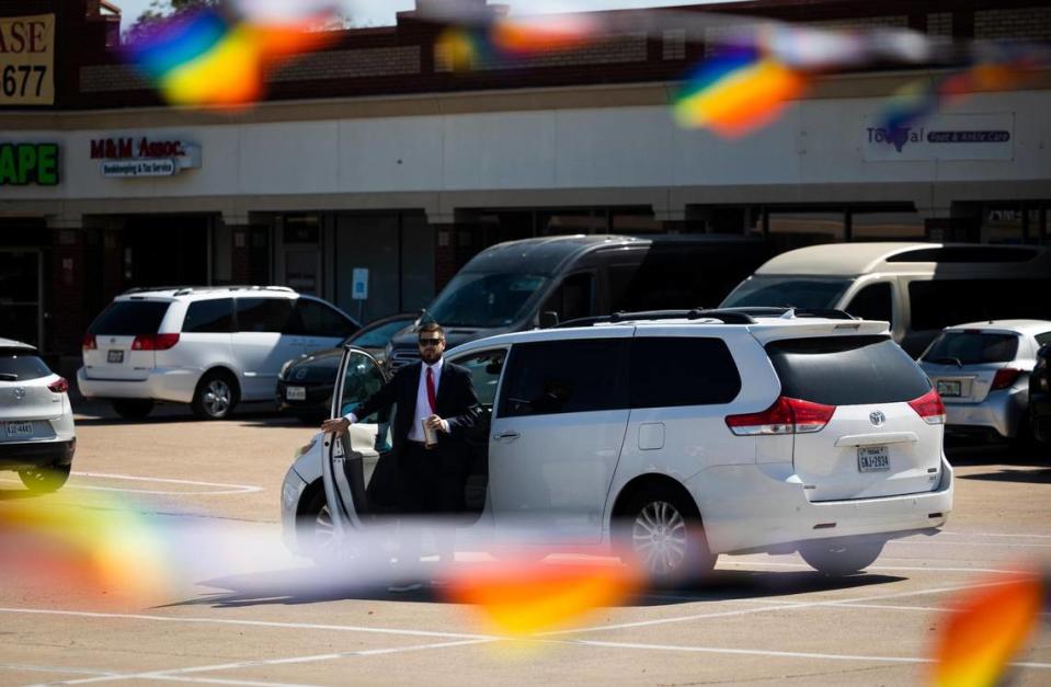 Pride flags stream in from the No Hate in Texas protest as Jonathan Shelley, leader of Stedfast Baptist Church, exits a vehicle in the parking lot outside the church. Shelley had said he is following teachings from the Bible and he is not advocating violence against homosexuals, or anyone.