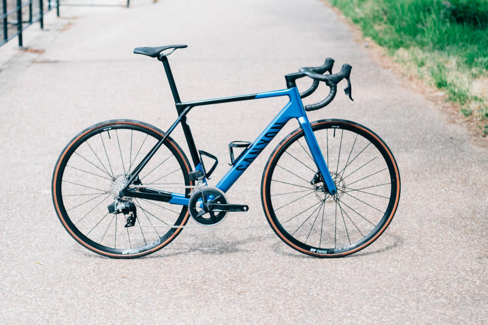 A Canyon Ultimate road bike stands on a paved canal path