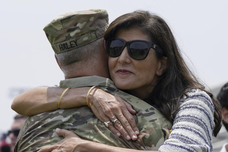 Republican presidential candidate Nikki Haley, right, hugs her husband, Maj. Michael Haley, following a deployment for his unit of the South Carolina National Guard unit on Saturday, June 17, 2023, in Charleston, S.C. Michael Haley's year-long deployment to Africa will encompass much of his wife's campaign for the 2024 GOP presidential nomination. (AP Photo/Meg Kinnard)