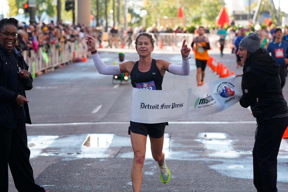 Kate Landau, of Tacoma, Washington, crosses the finish line in first place for the women's full marathon during the 46th Annual Detroit Free Press Marathon presented by MSU Federal Credit Union in Detroit on Sunday, Oct. 15, 2023.