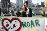 People clean the streets during ongoing anti-government protests in downtown Beirut,