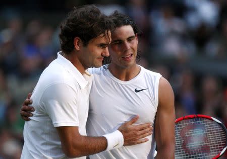 FILE PHOTO: Rafael Nadal of Spain (R) is embraced by Roger Federer of Switzerland after defeating him in their finals match at the Wimbledon tennis championships in London, Britain, July 6, 2008. REUTERS/Pool/File Photo