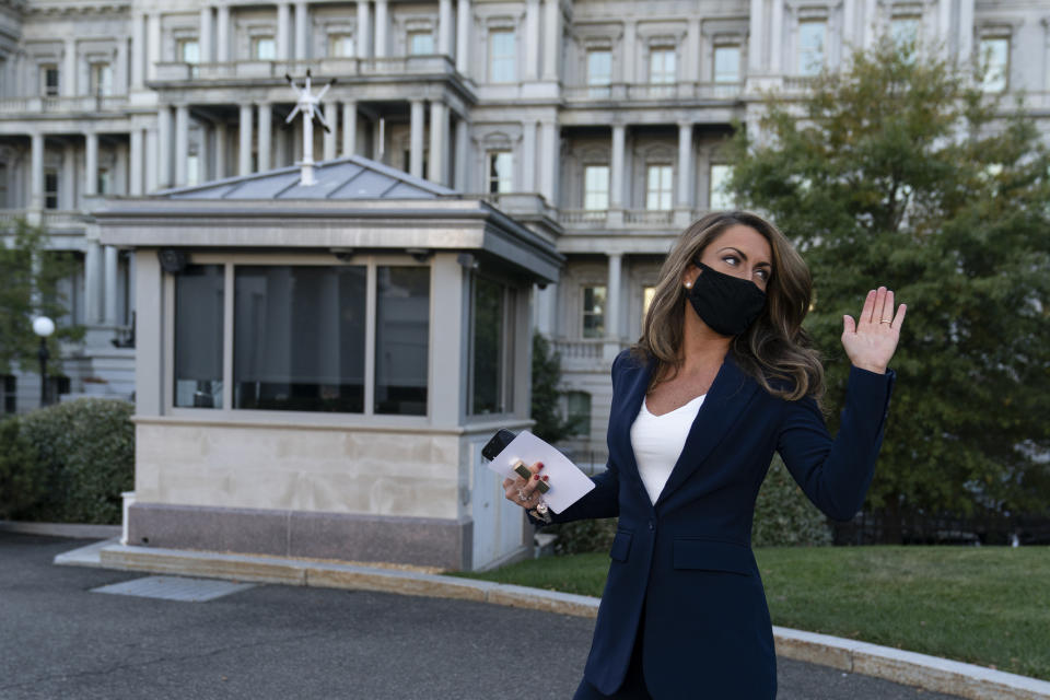 White House director of communications Alyssa Farah waves after speaking with reporters at the White House, Thursday, Oct. 8, 2020, in Washington. (AP Photo/Alex Brandon)