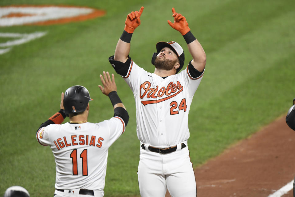 Baltimore Orioles' DJ Stewart (24) celebrates his home run with teammate Jose Iglesias (11) during the third inning of a baseball game against the Atlanta Braves, Monday, Sept. 14, 2020, in Baltimore. (AP Photo/Terrance Williams)