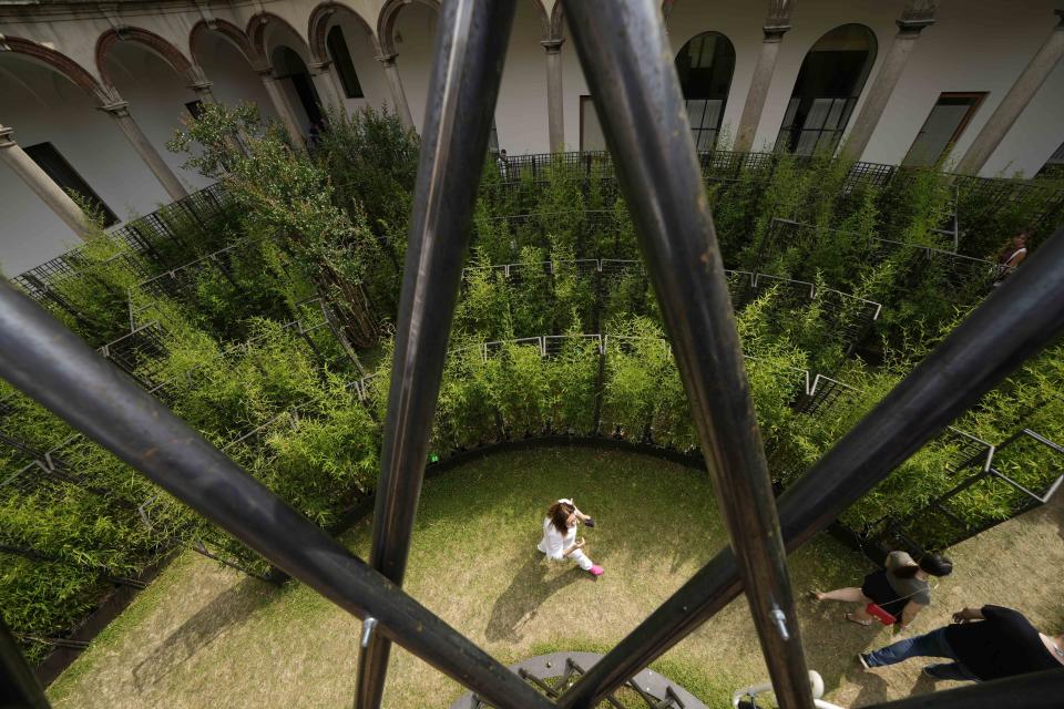 Visitors enjoy 'Labyrinth garden' by Raffaello Galliotto designer, for Nardi outdoor, part of the 'Fuorisalone', during the Design Fair exhibition, at the Statale University courtyard, in Milan, Italy, Wednesday, June 8, 2022. The Milan furniture and design week fair is a six-day event which ends next Sunday. (AP Photo/Luca Bruno)