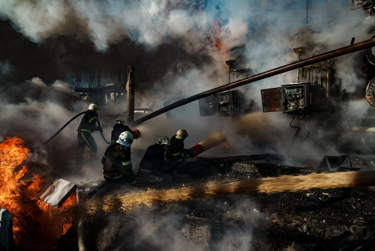 Ukrainian firefighters battling flames at a power station hit by Russian missiles. <a href="https://www.gettyimages.com/detail/news-photo/firefighters-work-to-put-out-a-fire-at-chp-power-station-news-photo/1432474994?phrase=russia%20ukraine%20power%20plant&adppopup=true" rel="nofollow noopener" target="_blank" data-ylk="slk:Serhii Mykhalchuk/Global Images Ukraine via Getty Images;elm:context_link;itc:0;sec:content-canvas" class="link ">Serhii Mykhalchuk/Global Images Ukraine via Getty Images</a>