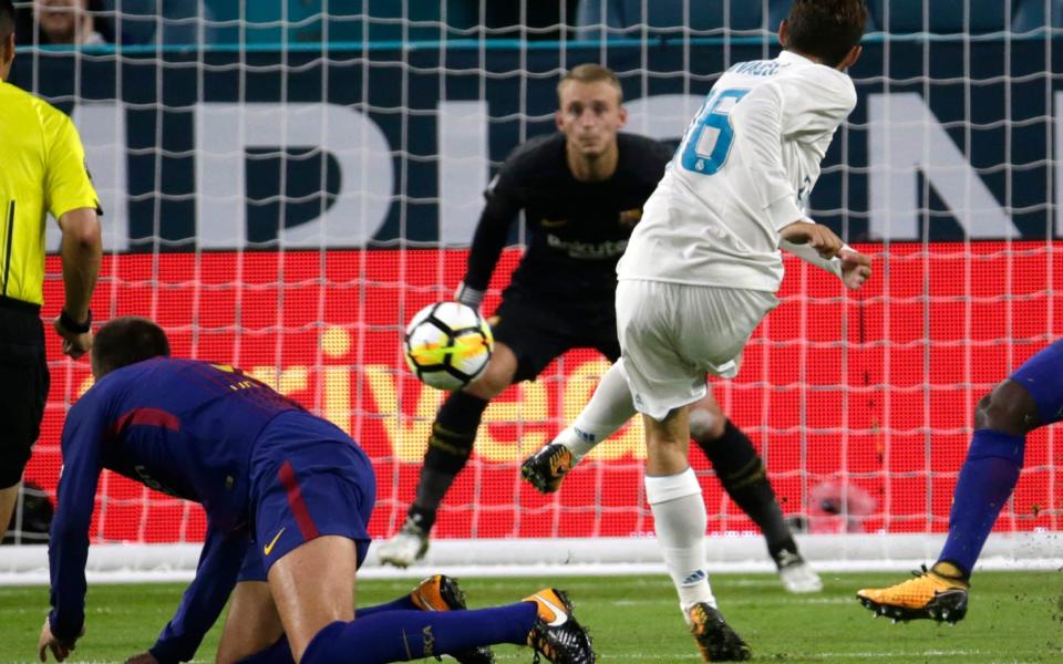 Real Madrid's Mateo Kovacic (16) scores past Barcelona goalkeeper Jasper Cillessen, center, during the first half of an International Champions Cup soccer match - Credit: AP