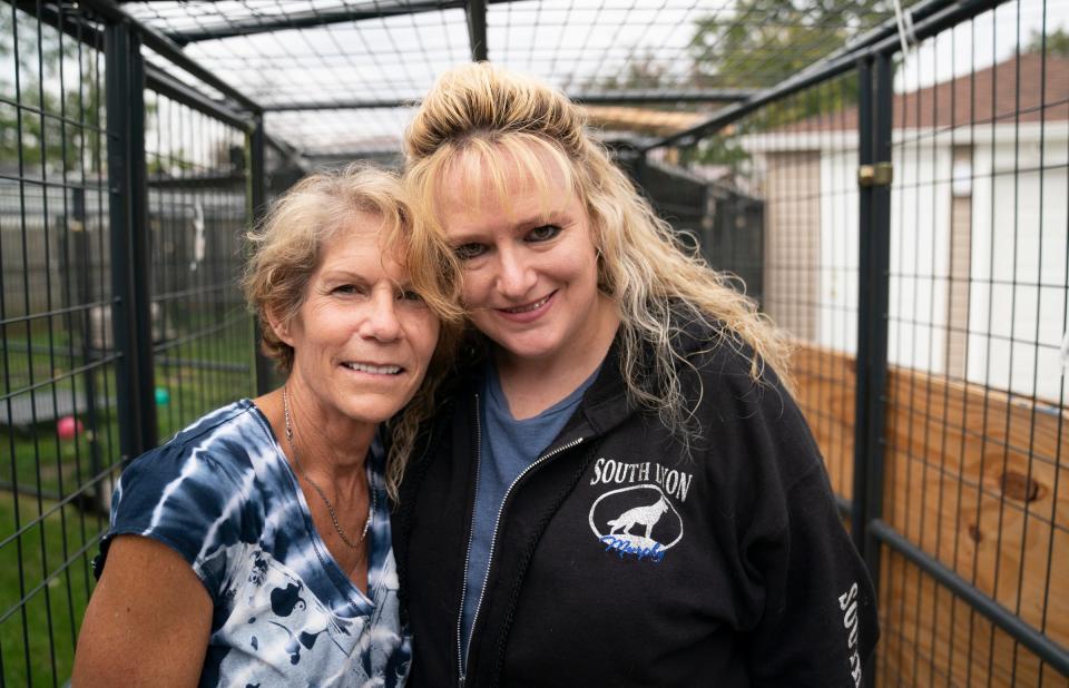 Elaine Westfall, of Royal Oak, left, stands with Heather Ineich, founder of South Lyon Murphy Lost Animal Recovery on October 14, 2021. Westfall had help from Ineich retrieving two of her escaped African caracal cats.