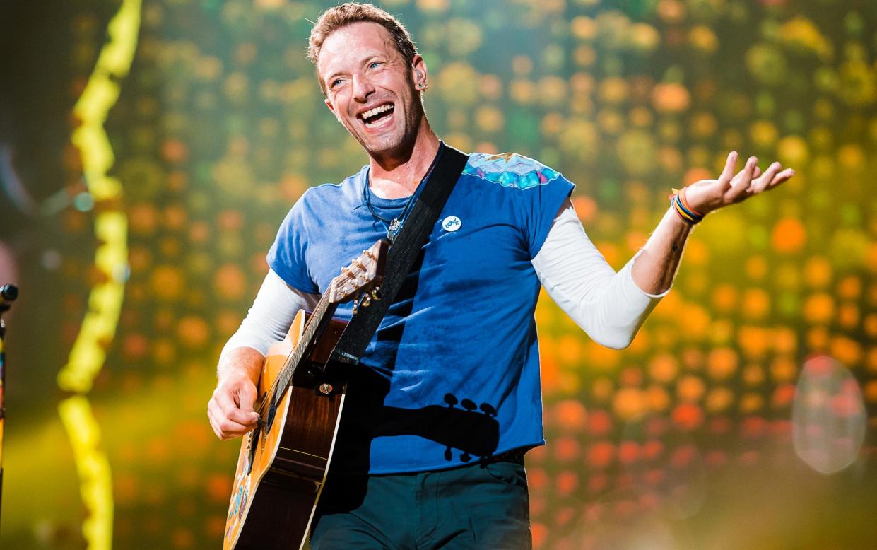 Chris Martin, pictured performing in Brazil, says it is ‘difficult’ to implement an eco-friendly alternative for flying