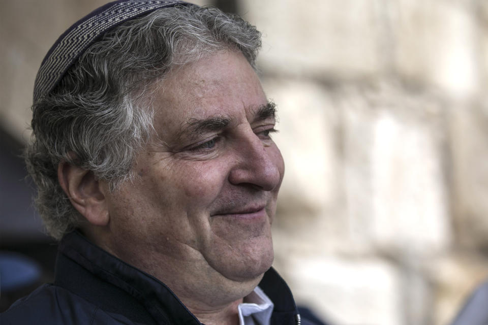 In this April 22, 2019 photo, American businessman Simon Falic attends the Cohanim Priestly caste during the Jewish holiday of Passover, at the Western Wall, in Jerusalem's old city. The Falic family, owners of the ubiquitous chain of Duty Free America shops, fund a generous, and sometimes controversial, philanthropic empire in Israel that stretches deep into the West Bank. The family supports many mainstream causes as well as far right causes considered extreme even in Israel. (AP Photo/Tsafrir Abayov)