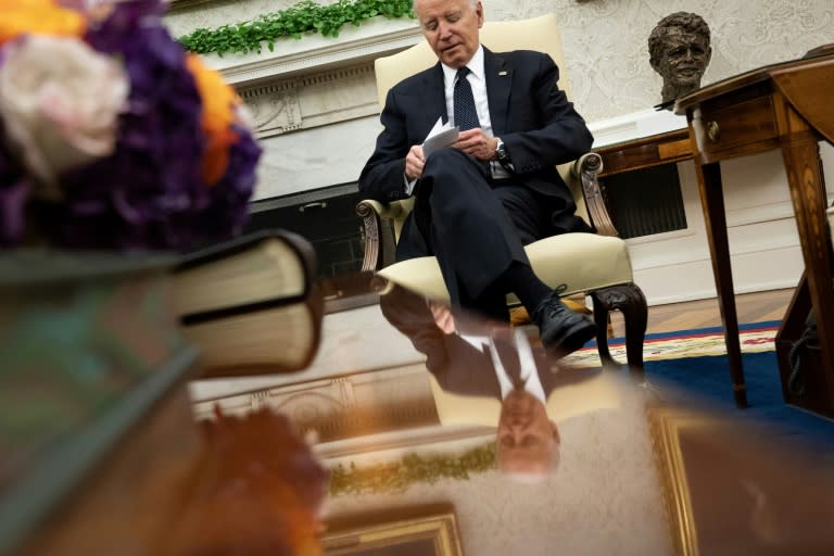 US President Joe Biden looks at note cards as he meets with Romanian President Klaus Iohannis in the Oval Office of the White House in Washington, DC, on May 7, 2024. (Brendan Smialowski)