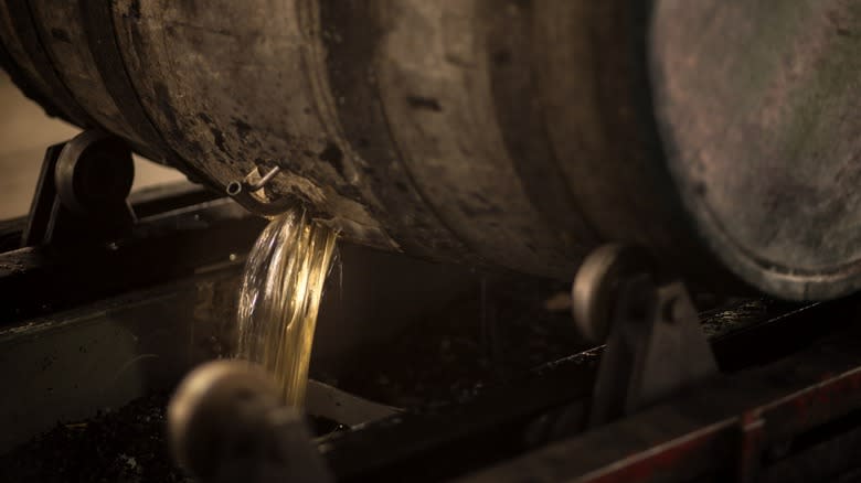 Whiskey pouring out of barrel