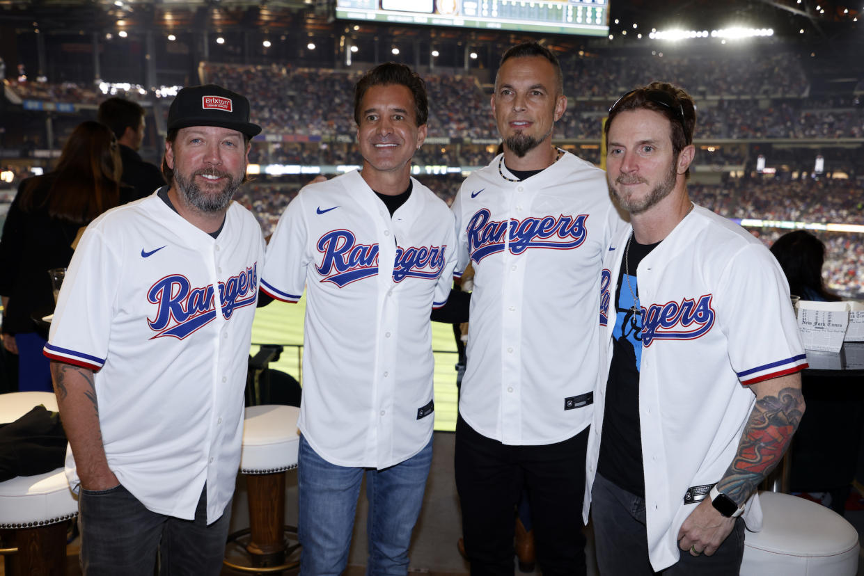Members of the band Creed pose for a photo during Game 3 of the ALCS. (Ron Jenkins/MLB Photos via Getty Images)
