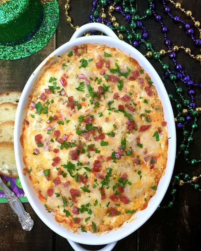<p>Grits and Pinecones</p><p>This flavorful dip is a tantalizing app with tasty green olives, salami, provolone cheese, and tangy giardiniera.</p><p><strong>Get the recipe:</strong><a href="https://www.gritsandpinecones.com/easy-mardi-gras-hot-muffuletta-dip/" rel="nofollow noopener" target="_blank" data-ylk="slk:Hot Muffuletta Dip;elm:context_link;itc:0;sec:content-canvas" class="link rapid-noclick-resp"> <strong>Hot Muffuletta Dip</strong></a></p>