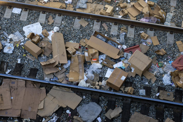 Shredded boxes and packages and debris are strewn along at a section of the Union Pacific train tracks in downtown Los Angeles Friday, Jan. 14, 2022. Thieves have been raiding cargo containers aboard trains nearing downtown Los Angeles for months, leaving the tracks blanketed with discarded packages. The sea of debris left behind included items that the thieves apparently didn't think were valuable enough to take, CBSLA reported Thursday. (AP Photo/Ringo H.W. Chiu)