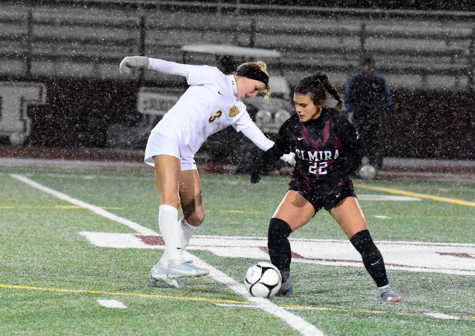 Arlington's Quinn Kapfhammer (3) and Elmira's Julianna Wilbur (22) battle for possession during Arlington's 6-0 victory in a Class AAA girls soccer subregional Nov. 1 2023 at Johnson City High School