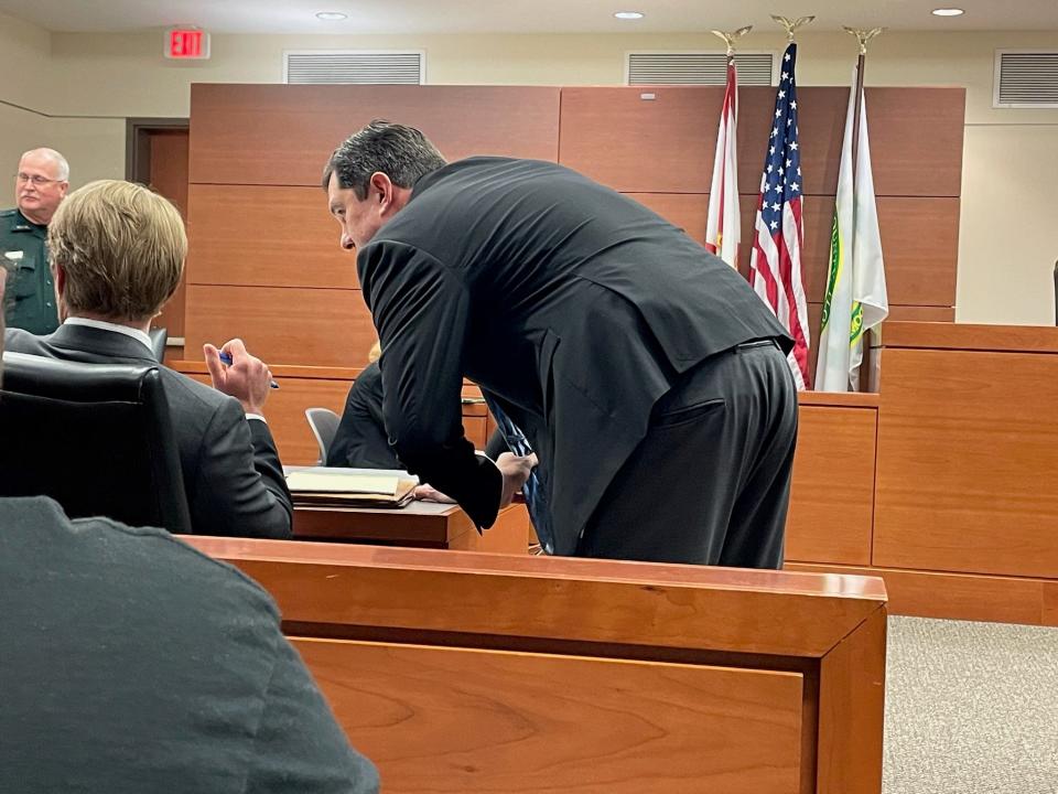 Lawyer Derek A. Schroth, right, chats with lawyer Rob Batsel at a hearing held last week in front of Circuit Judge Robert Hodges concerning the fire fee.