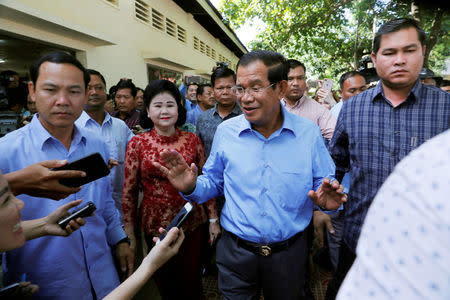 Cambodia's Prime Minister and President of the Cambodian People's Party (CPP) Hun Sen and his wife Bun Rany leave after voting during a general election in Takhmao, Kandal province, Cambodia July 29, 2018. REUTERS/Darren Whiteside