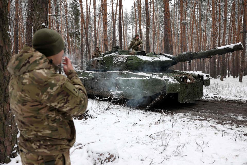 A Ukrainian tank crew member stands next to a Leopard 2A5 near the Lyman front line in Donetsk (Anatolii Stepanov/AFP via Getty Images)