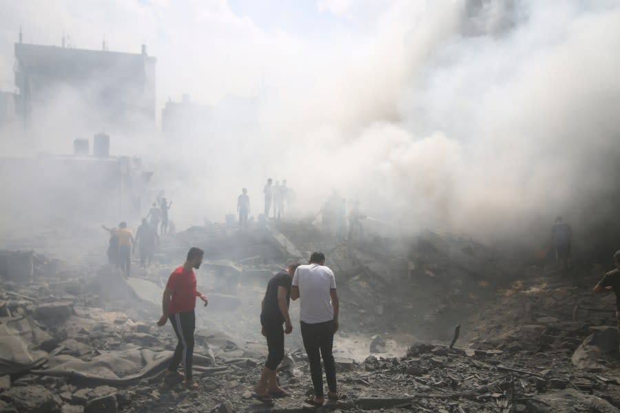 Palestinians look for survivors after an Israeli airstrike in Rafah refugee camp, southern Gaza Strip, Thursday, Oct. 12, 2023. (AP Photo/Hatem Ali)