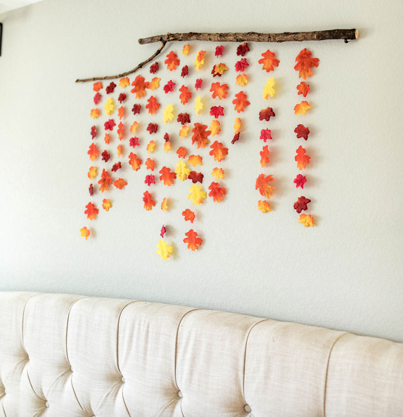 fall leaves hanging from stick on the wall