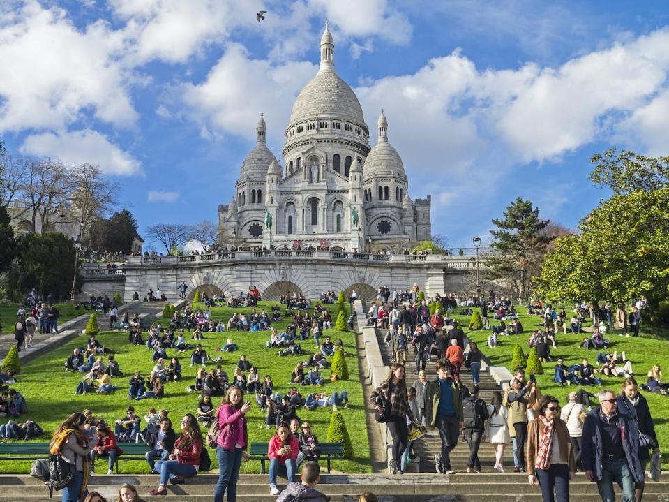 Tourists outside the Sacre-Coeur in Paris, France.