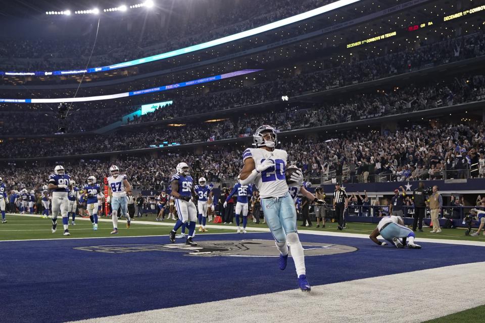 Dallas Cowboys' Tony Pollard (20) reacts after a touchdown run during the second half of an NFL football game against the Indianapolis Colts, Sunday, Dec. 4, 2022, in Arlington, Texas. (AP Photo/Tony Gutierrez)