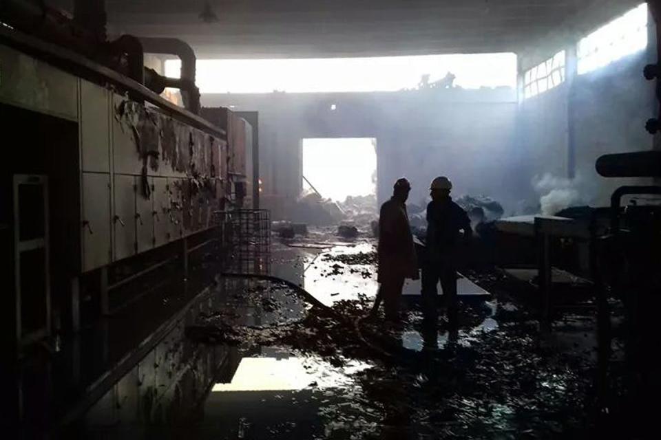 Firefighters in a factory torched by an angry mob in Jhelum, Pakistan, after one of the factory’s employees was accused of desecrating the Quran, Nov. 21, 2015. <a href="https://www.gettyimages.com/detail/news-photo/pakistani-firefighters-stand-in-a-burnt-out-factory-torched-news-photo/498134476?adppopup=true" rel="nofollow noopener" target="_blank" data-ylk="slk:STR/AFP via Getty Images;elm:context_link;itc:0;sec:content-canvas" class="link ">STR/AFP via Getty Images</a>