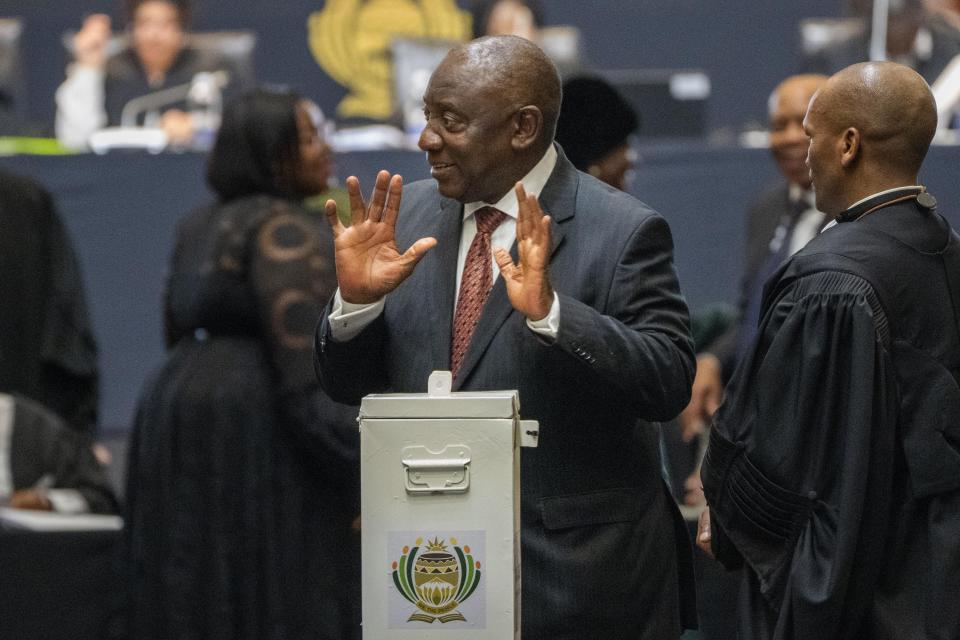 South African President Cyril Ramaphosa reacts after casting his vote for speaker of the National Assembly in Cape Town, South Africa, Friday, June 14, 2024. Ramaphosa was expected to be reelected for a second term Friday after his African National Congress party signed a last-minute coalition agreement with its long-time political rival during the first sitting of the new Parliament. (AP Photo/Jerome Delay)