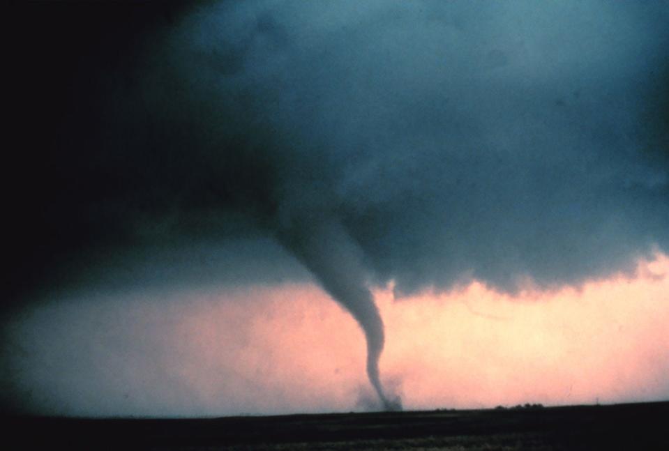 A tornado cloud in front of a pinkish sky