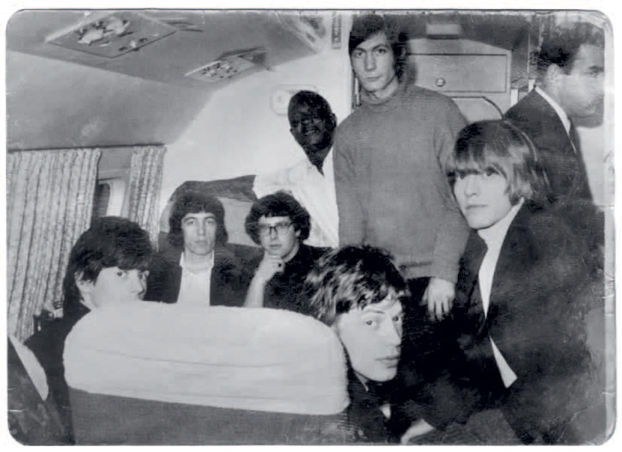 The Rolling Stones at home, with Mankowitz (center, wearing glasses)