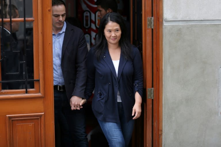 Peruvian opposition leader Keiko Fujimori, leader of the opposition Popular Force party, left the courthouse smiling and waving to photographers beside her husband, Mark Vito