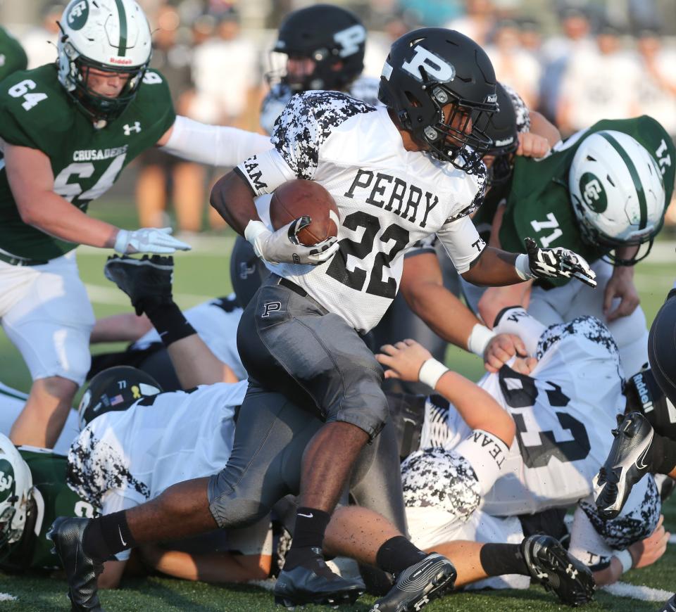 Perry's De'Andre Church (22) picks up yardage during their season-opening game at Central Catholic on Thursday, August 19, 2021.