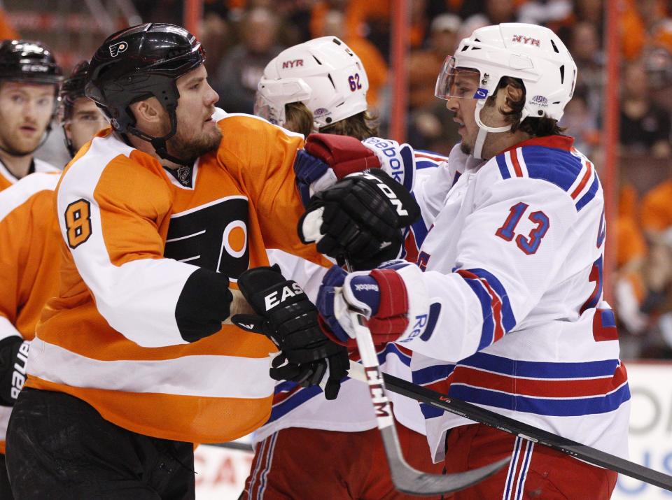 Philadelphia Flyers' Nicklas Grossmann, left, of Sweden, gets into a pushing match with New York Rangers' Daniel Carcillo during the first period in Game 3 of an NHL hockey first-round playoff series, Tuesday, April 22, 2014, in Philadelphia. (AP Photo/Chris Szagola)