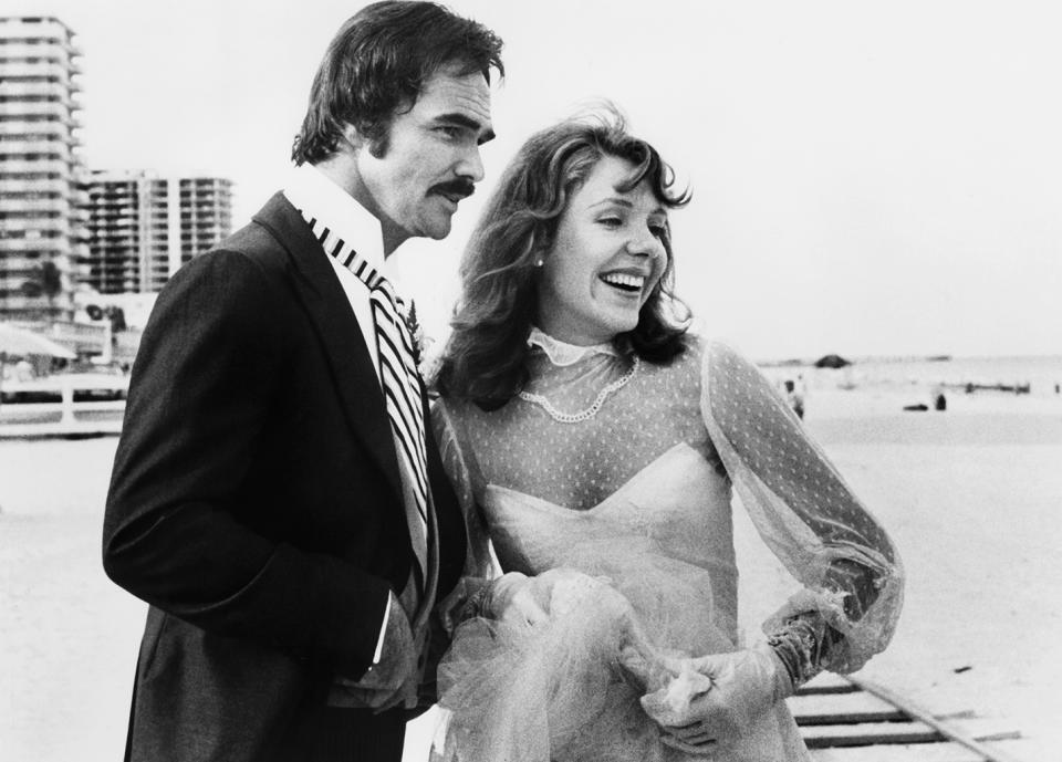 <p>Reynolds found himself playing a former football player again as Billy Clyde Puckett in <em>Semi-Tough</em>. He’s seen here with actress Jill Clayburgh in the 1977 romantic comedy. (Photo: United Artists/courtesy Everett Collection) </p>