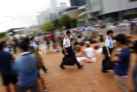 Police officers arrive at an area blocked by protesters outside of Hong Kong's Chief Executive Leung Chun-ying offices in Hong Kong, October 2, 2014. REUTERS/Carlos Barria