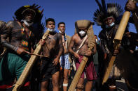 Indigenous men perform a ritual during the "Luta pela Vida," or Struggle for Life mobilization, a protest to pressure Supreme Court justices who are expected to issue a ruling that will have far-reaching implications for tribal land rights, outside the Supreme Court in Brasilia, Brazil, Wednesday, Aug. 25, 2021. (AP Photo/Eraldo Peres)