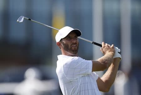 U.S. team member Dustin Johnson watches his tee shot on the fifth hole during the opening foursome matches of the 2015 Presidents Cup golf tournament at the Jack Nicklaus Golf Club in Incheon, South Korea, October 8, 2015. REUTERS/Kim Hong-Ji