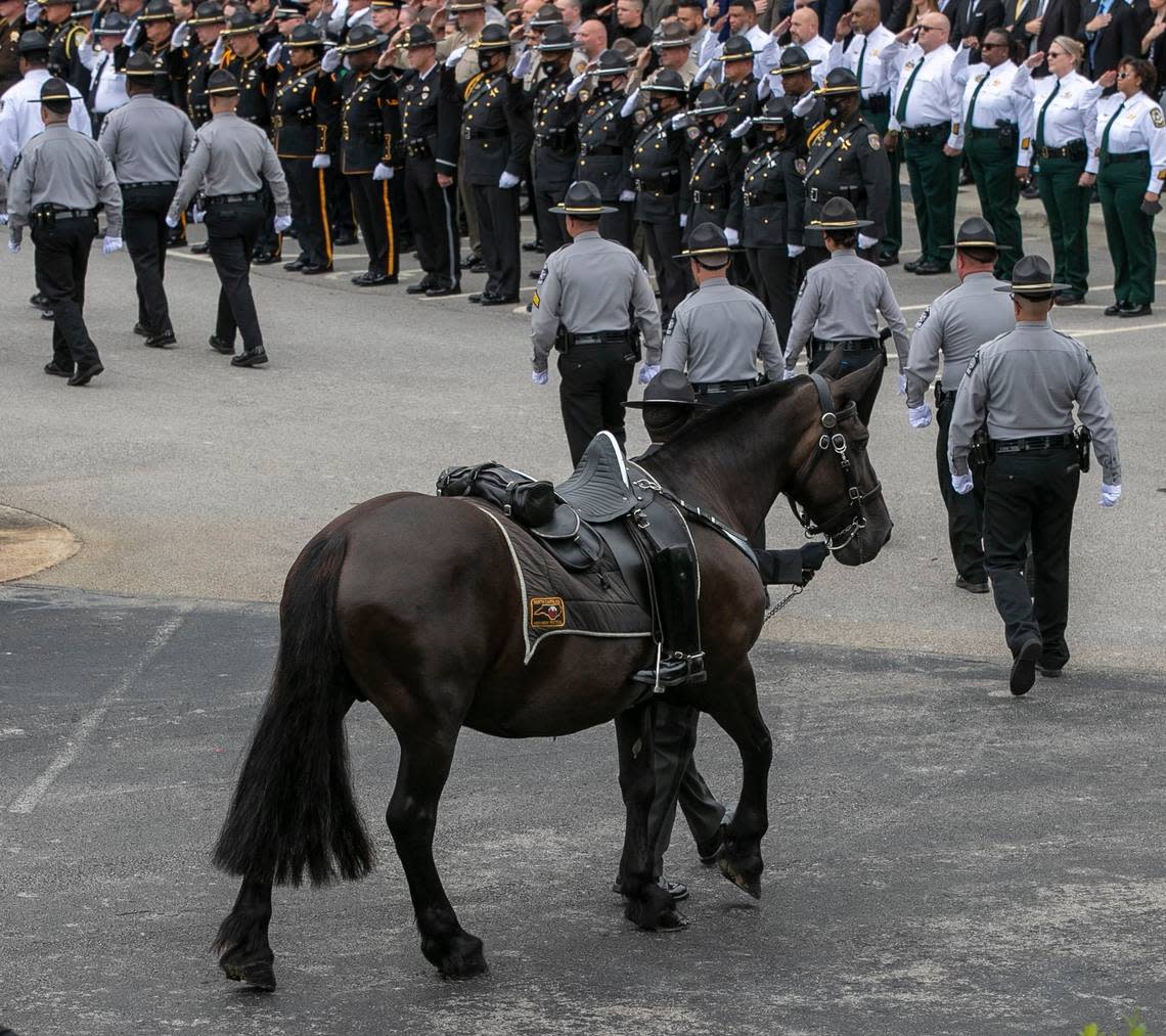 A riderless horse from the North Carolina State Highway Patrols Caisson Unit brings up the rear of the procession to Wake County Deputy Ned Byrds at Providence Baptist Church on Friday, August 19, 2022 in Raleigh, N.C.