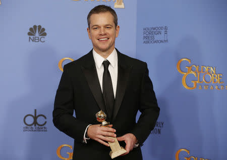 Matt Damon poses backstage with the award for Best Performance by an Actor in a Motion Picture - Musical or Comedy for his role in "The Martian" at the 73rd Golden Globe Awards in Beverly Hills, California January 10, 2016. REUTERS/Lucy Nicholson