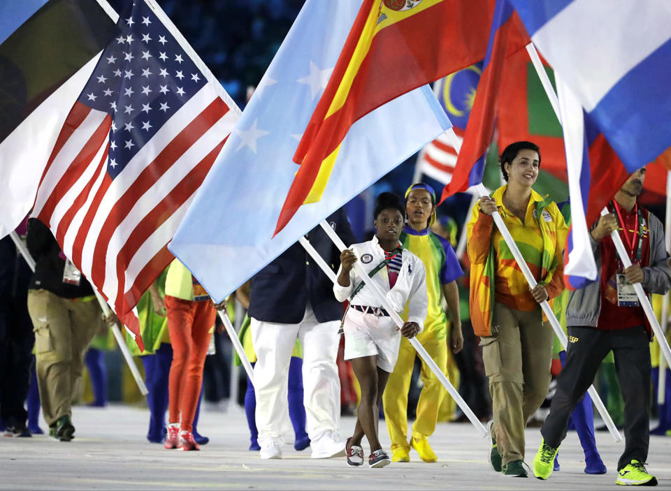 <p>Simone Biles carries the flag of the United States of America during the closing ceremony in the Maracana stadium at the 2016 Summer Olympics in Rio de Janeiro, Brazil, Sunday, Aug. 21, 2016. (AP Photo/Matt Dunham) </p>