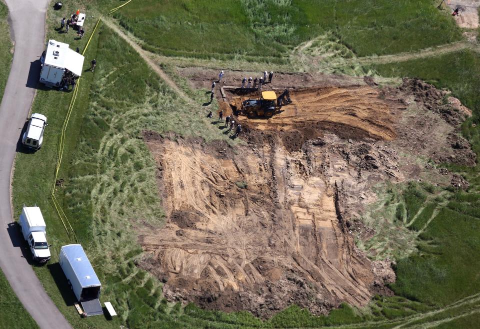 Investigators using a backhoe dig through a foundation of what used to be a barn in Oakland Township as they search for the remains of Jimmy Hoffa on June 18, 2013. Acting on a tip, the dig began yesterday afternoon to find the Teamsters boss who went missing 30 years ago from a restaurant parking lot in Bloomfield Township.