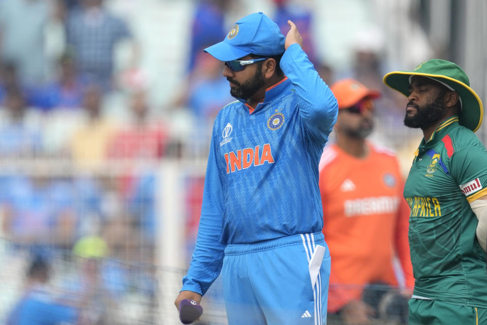 India's captain Rohit Sharma and South Africa's captain Temba Bavuma arrive for coin toss at the start of the ICC Men's Cricket World Cup match between India and South Africa in Kolkata, India, Sunday, Nov. 5, 2023. (AP Photo/Bikas Das)