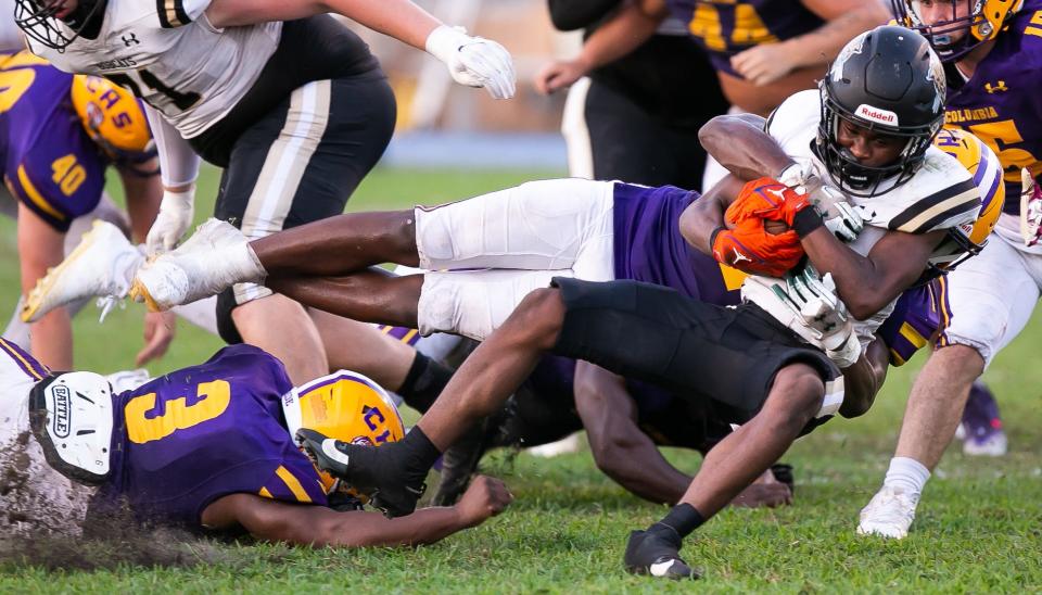 Columbia High School Kani Fulton (1) takes down Buchholz High School running back Quinton Cutler (10). The Buchholz Bobcats hosted the Columbia Tigers at Citizens Field in Gainesville, FL on Saturday, August 26, 2023. The two teams had to reschedule the game after lightning and an incident that occurred at Columbia High School Friday night. They were able to complete one quarter with Buchholz leading 14-0 after the delay Friday night. [Doug Engle/Ocala Star Banner]