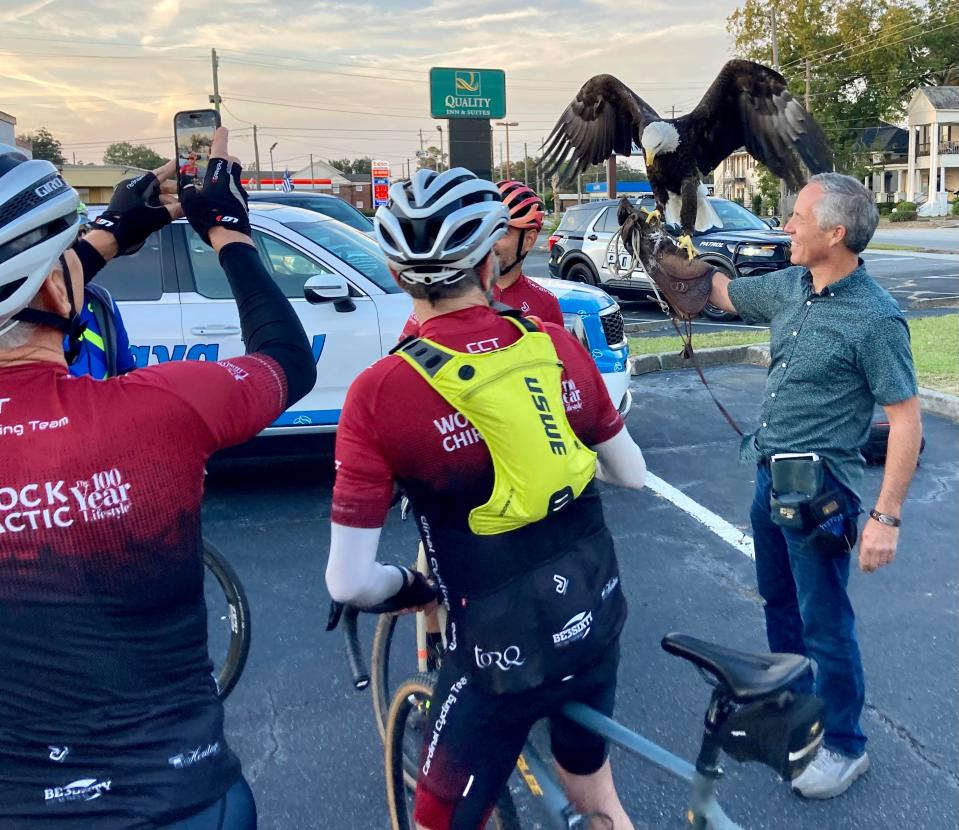 Steve Hine from Georgia Southern's Wildlife Center introduces bald eagle, Freedom, to eager riders. Freedom is the mascot for Georgia Southern University.
