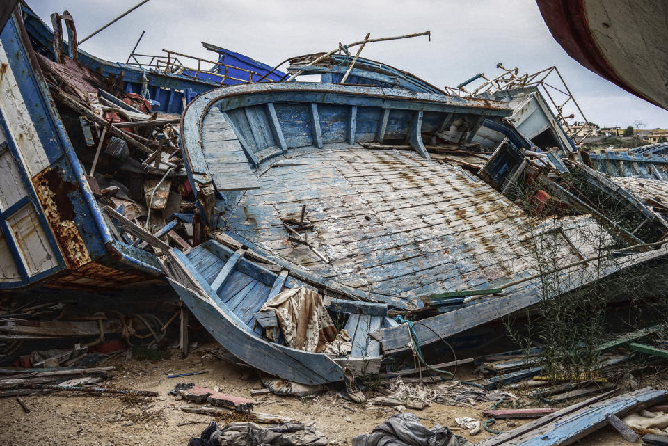 LAMPEDUSA, ITALY - SEPTEMBER 8: A migrant ship graveyard on September 8, 2014 in Lampedusa, Italy. In the early days of mass migration from North Africa, Italian authorities would tow the ships full of migrants into the port, where they dumped into this boatyard. Nowadays, Italian authorities are ordered to destroy the migrant boats at sea after having transferred the migrants onto coast guard boats. Many of the boats are bought by human trafficking gangs for the sole purpose of transporting migrants over the Mediterranean Sea. They're often steered by inexperienced and poorly trained crew members.(Photo by Giles Clarke/Getty Images)