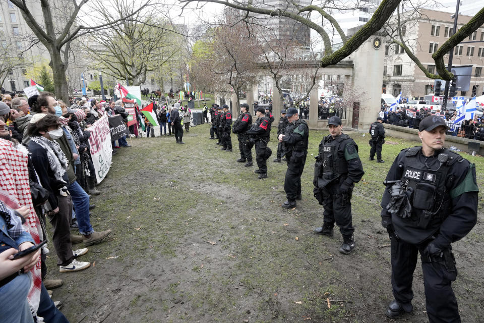 Police separate pro-Palestinian and pro-Israel demonstrators on the outskirts of a protest encampment on the grounds of McGill University, in Montreal, Thursday, May 2, 2024. (Ryan Remiorz/The Canadian Press via AP)