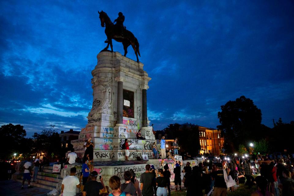 People gather around the statue of Robert E. Lee in Richmond, Virginia, amid continued protests over the death of George Floyd.